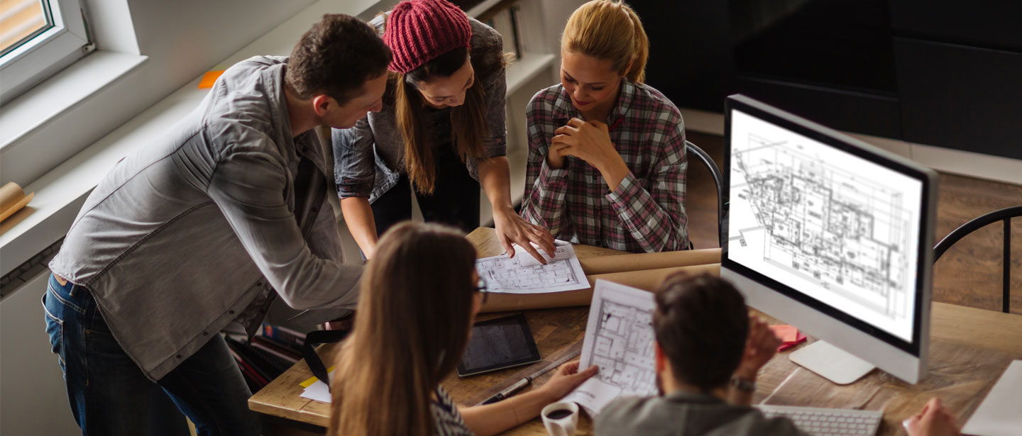 gruppe mennesker som ser på en mac