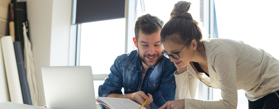 students in front of a desk